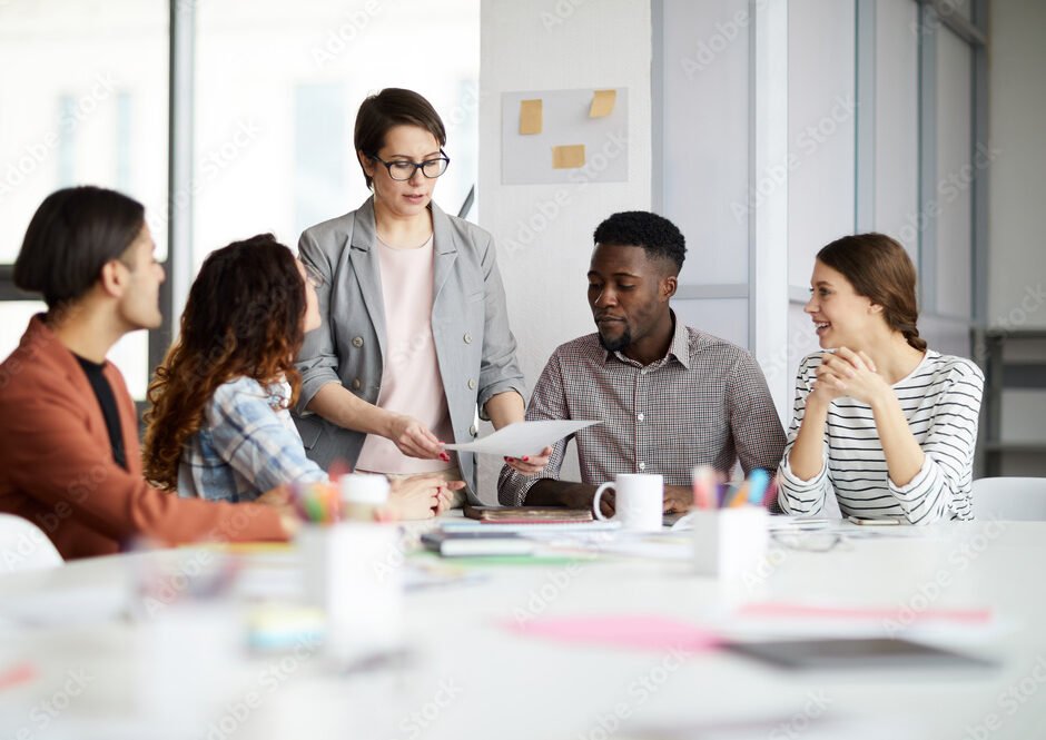 Portrait of successful female manager leading multi-ethnic team in meeting, copy space